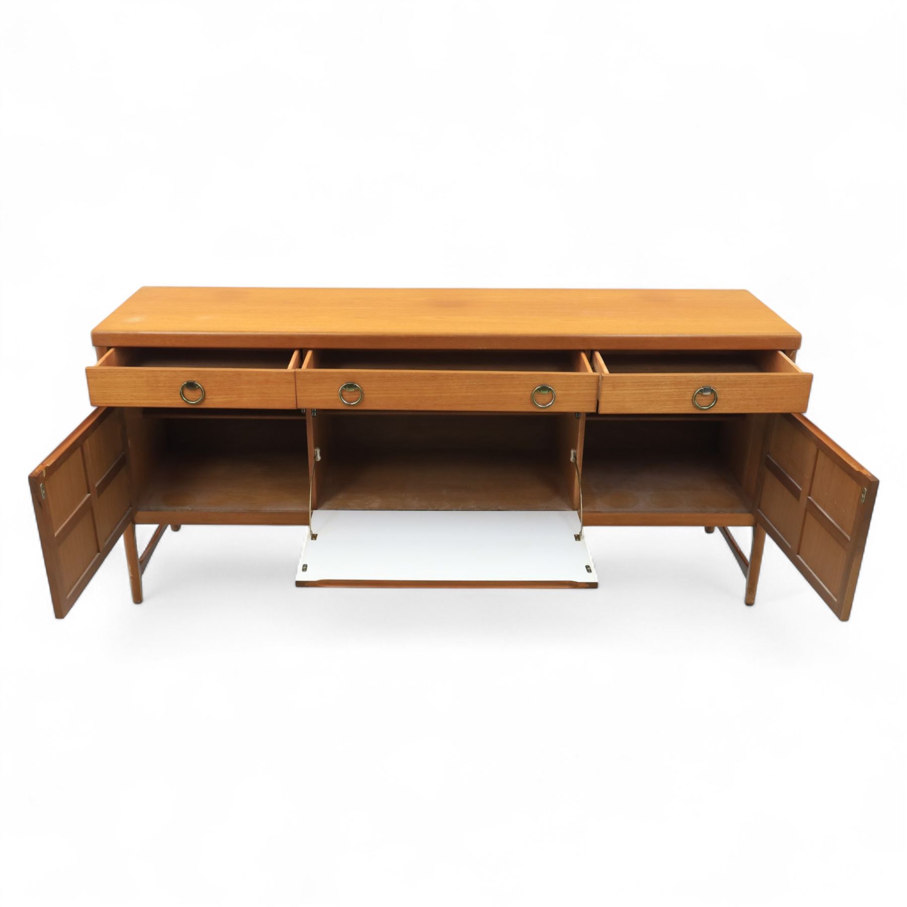 Nathan - mid 20th century teak sideboard, fitted with three drawers with brass ring handles, above a central fall front cabinet, flanked by two cupboard doors, raised on square tapering supports