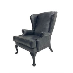 Wingback armchair, upholstered in black patch work fabric, on cabriole supports 