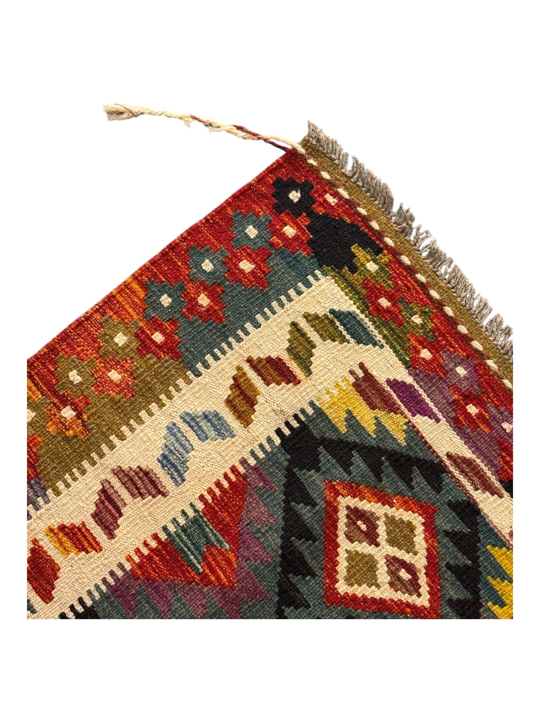 Afghan Maimana Kilim flatweave rug, dark teal ground with a multicoloured diamond lattice, framed by a wide border of stylised motifs, finished with braided corner tassels