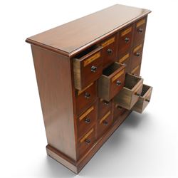 Victorian style mahogany stained chemist’s cabinet, rectangular moulded top over sixteen small drawers, each fitted with turned knob handle and applied gilt paper pharmaceutical labels, on moulded plinth base
