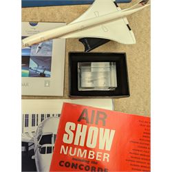 Collection of Concorde memorabilia, including paperweight, limited edition print, calendars, scale model, etc 