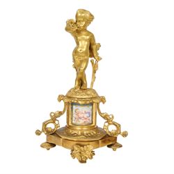 Pair of 19th century ormolu putto figures, each modelled stood with foliate support to backs, upon a naturalistic base upon cylindrical plinth each with twin leafy tendril supports, each plinth with inset Sevres type painted panel of a cherub, upon a shaped base with four compressed disk feet, the front facing with leaf mount, H29cm
