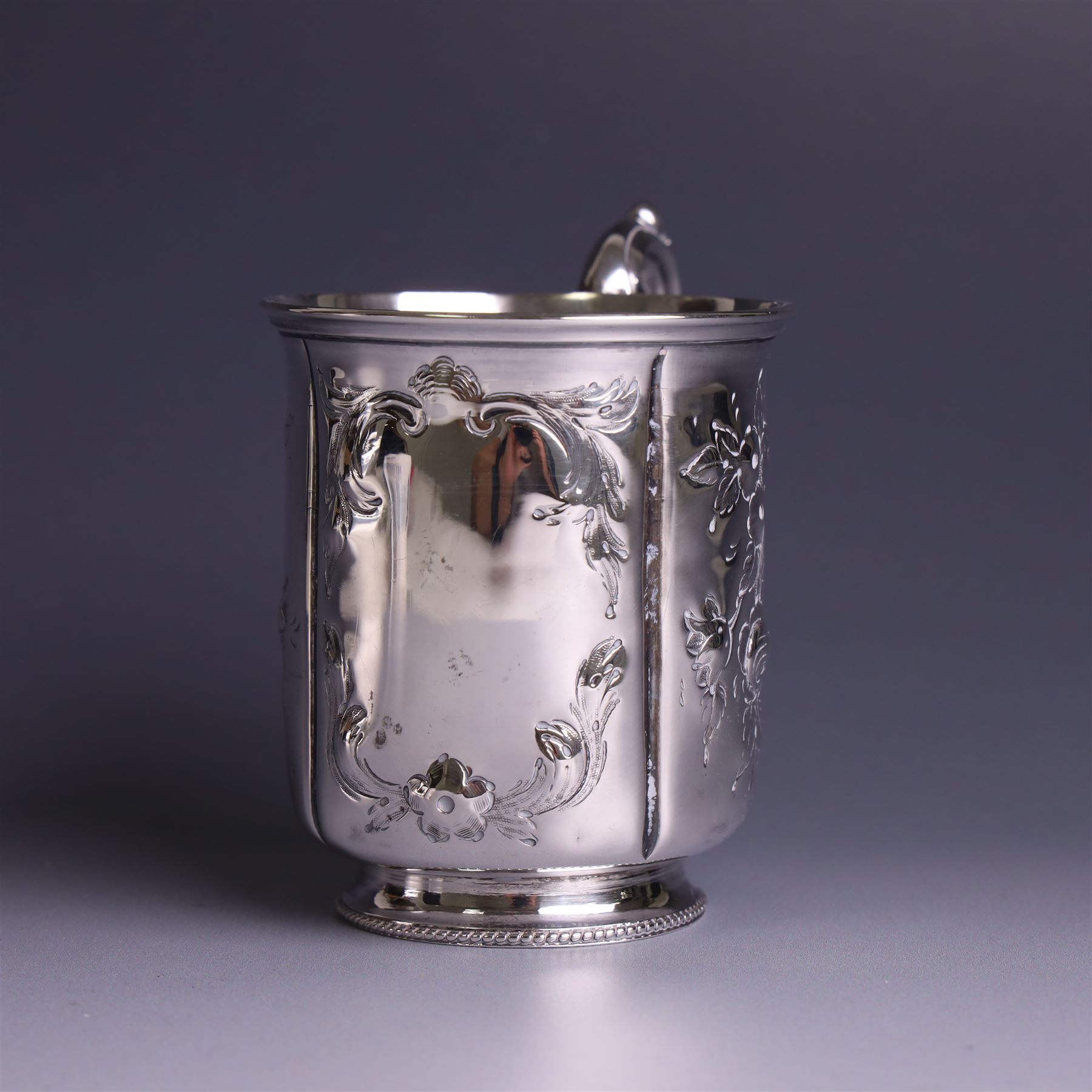 Victorian silver christerning mug, of cylindrical form with four panels of embossed floral decoration, hallmarked H J Lias & Son, London 1876, H10cm