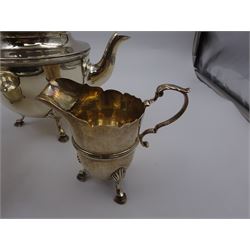 1920s three piece silver tea service, comprising teapot, with ebonised wooden handle and finial, milk jug and open sucrier, all of circular form, with shaped rims, and upon three hoof feet, hallmarked Wakely & Wheeler, London 1922, teapot H19cm
