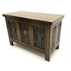 Mid to late 20th century carved panelled oak coffer, hinge lid, raised on stile supports 