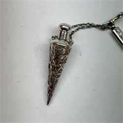 Victorian and later silver chatelaine, the shaped and foliate pierced clasp with embossed oval panel of a courting couple, hallmarked Levi & Salaman, Birmingham 1899, supporting six accessories on five chains: a circular mirror embossed with putti, hallmarked Henry Matthews, Birmingham 1911, pencil holder engraved with foliate scrolls, hallmarked Francis Webb, Birmingham 1914, conical scent bottle decorated with bamboo, (unmarked but testing as silver), aide memoire embossed with putti, hallmarked Samuel M Levi, Birmingham 1911, tape measure of compressed spherical form, hallmarked Henry Matthews, Birmingham 1899, and a purse with embossed putti, hallmarked Birmingham 1909, makers mark worn and indistinct, at longest point L31cm

