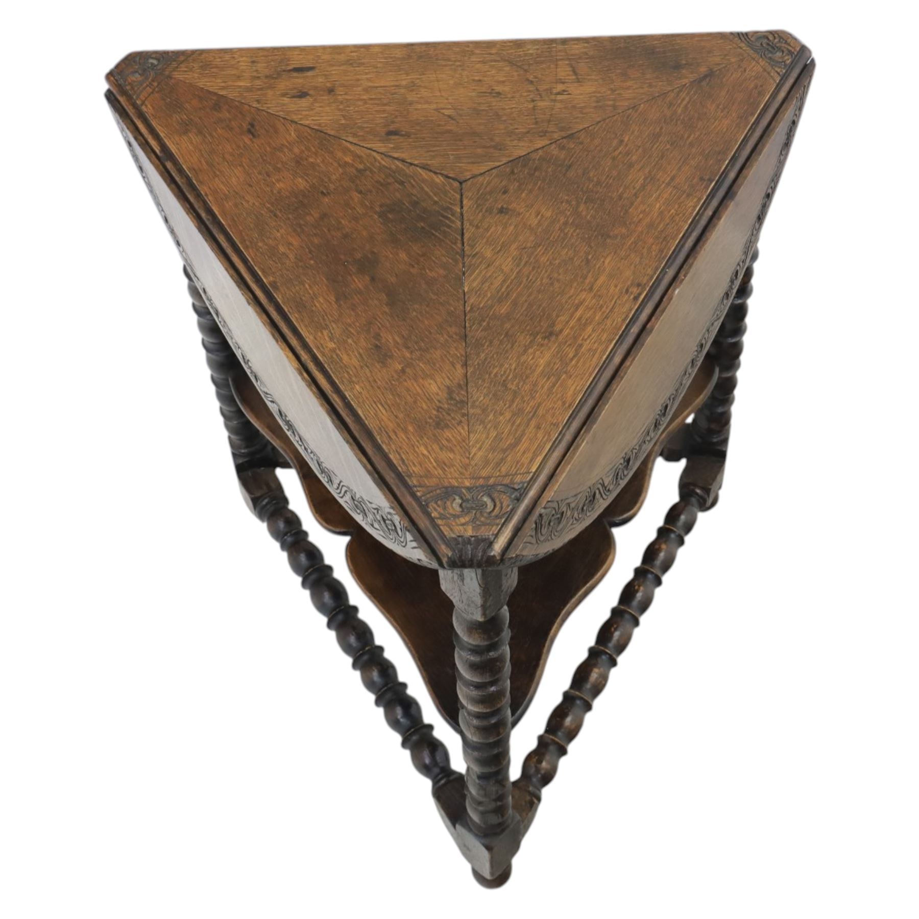 19th century country oak circular occasional table, featuring three triangular drop leaves, above shaped middle tier shelf, raised on bobbin turned legs and joining stretchers