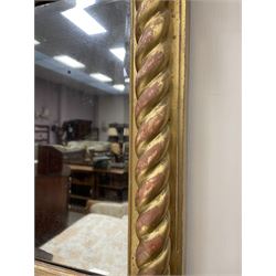 Regency triple glass overmantel mirror, projecting cornice over frieze set with moulded decoration, rope twist upright pilasters, bevelled glass
