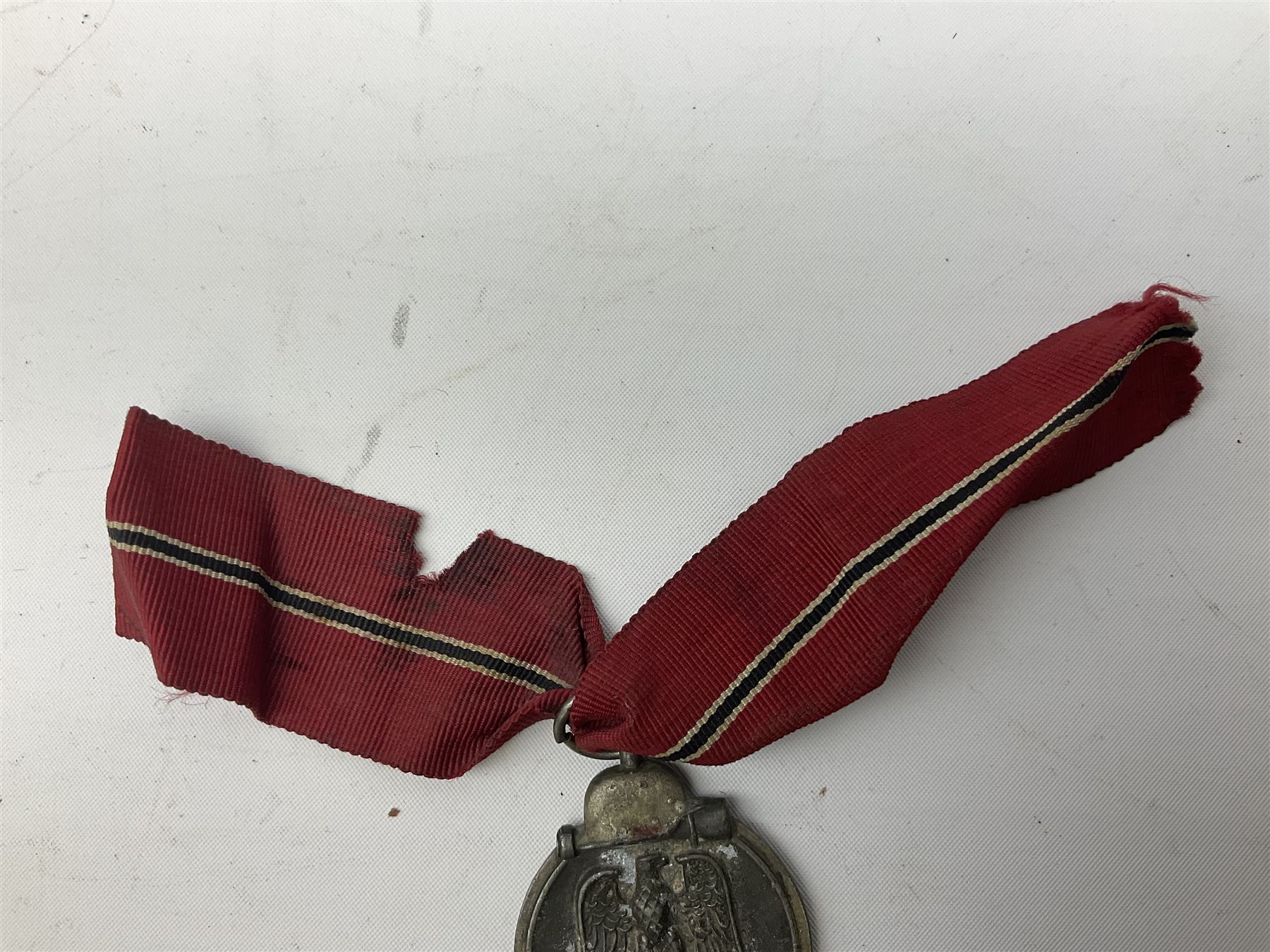WW2 German Eastern Front Medal awarded to those who served on the German Eastern/Russian Front during the Winter Campaign period of 15th November 1941 to 15th April 1942 with original ribbon; and German War Merit Cross with swords 2nd Class (2)