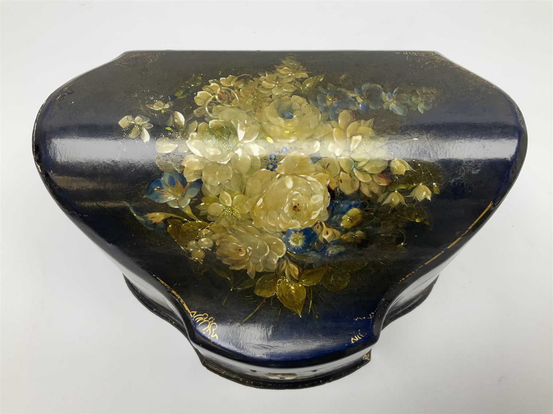 Victorian papier-mâché stationary box, of rounded wedge form with mother of pearl escutcheon, the hinged and curved cover and sides hand painted with floral sprays, opening to reveal a lined and fitted interior, H15cm L22cm D16cm