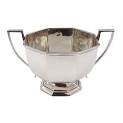 Early 20th century silver porridge bowl, of faceted octagonal form, wit angular twin handles and upon conforming stepped foot, hallmarked Skinner & Co, London 1913