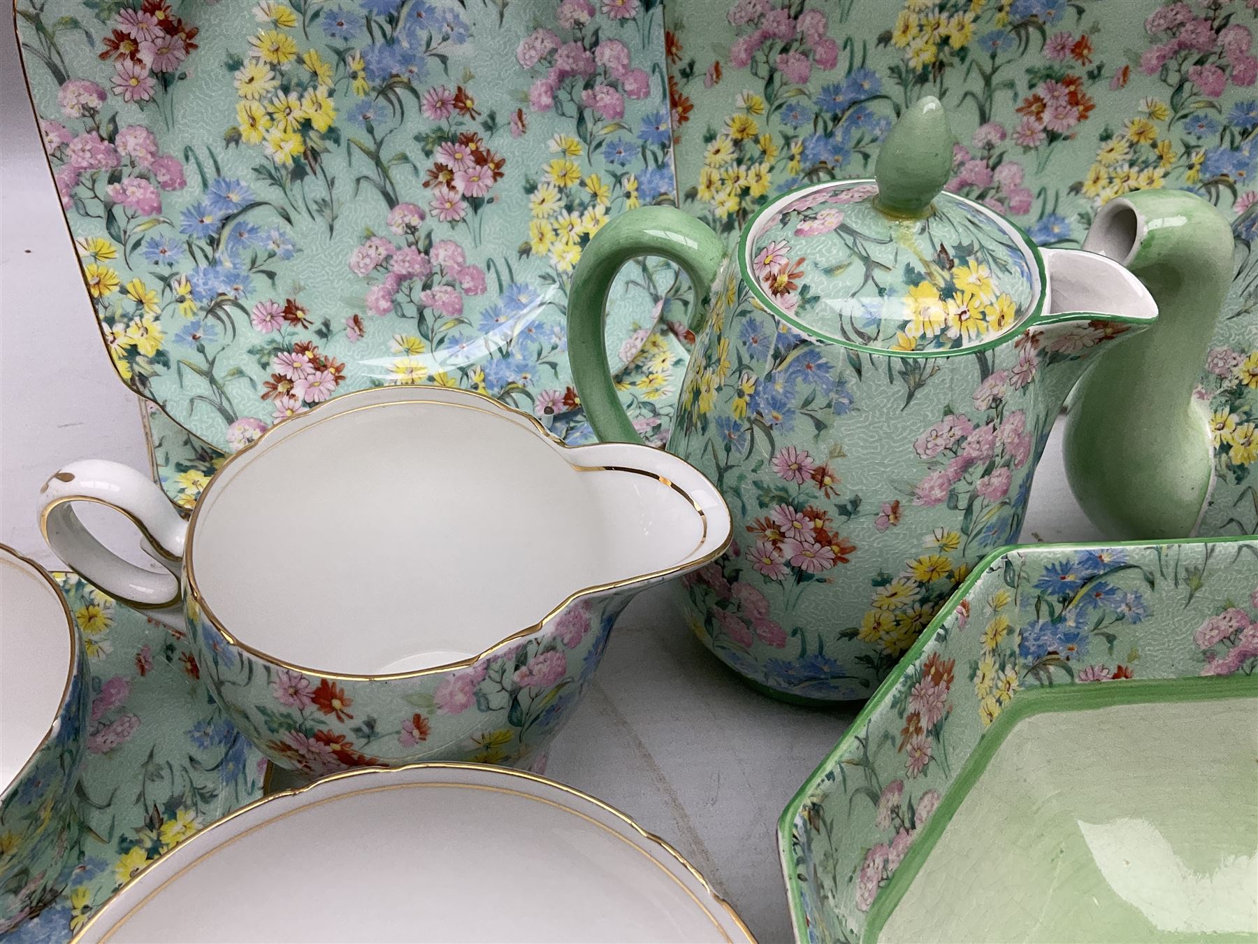 Shelley Melody pattern tea service for six, to include teapot, teapot stand, hot water jug, milk jug, covered sucrier, teacups and saucers, cake plates etc (31)