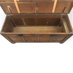 Large 17th century oak coffer, plank top with moulded edge, four panel front with channel moulded uprights, retaining original wrought iron strap hinges and central lock plate, panelled ends, raised on stile supports