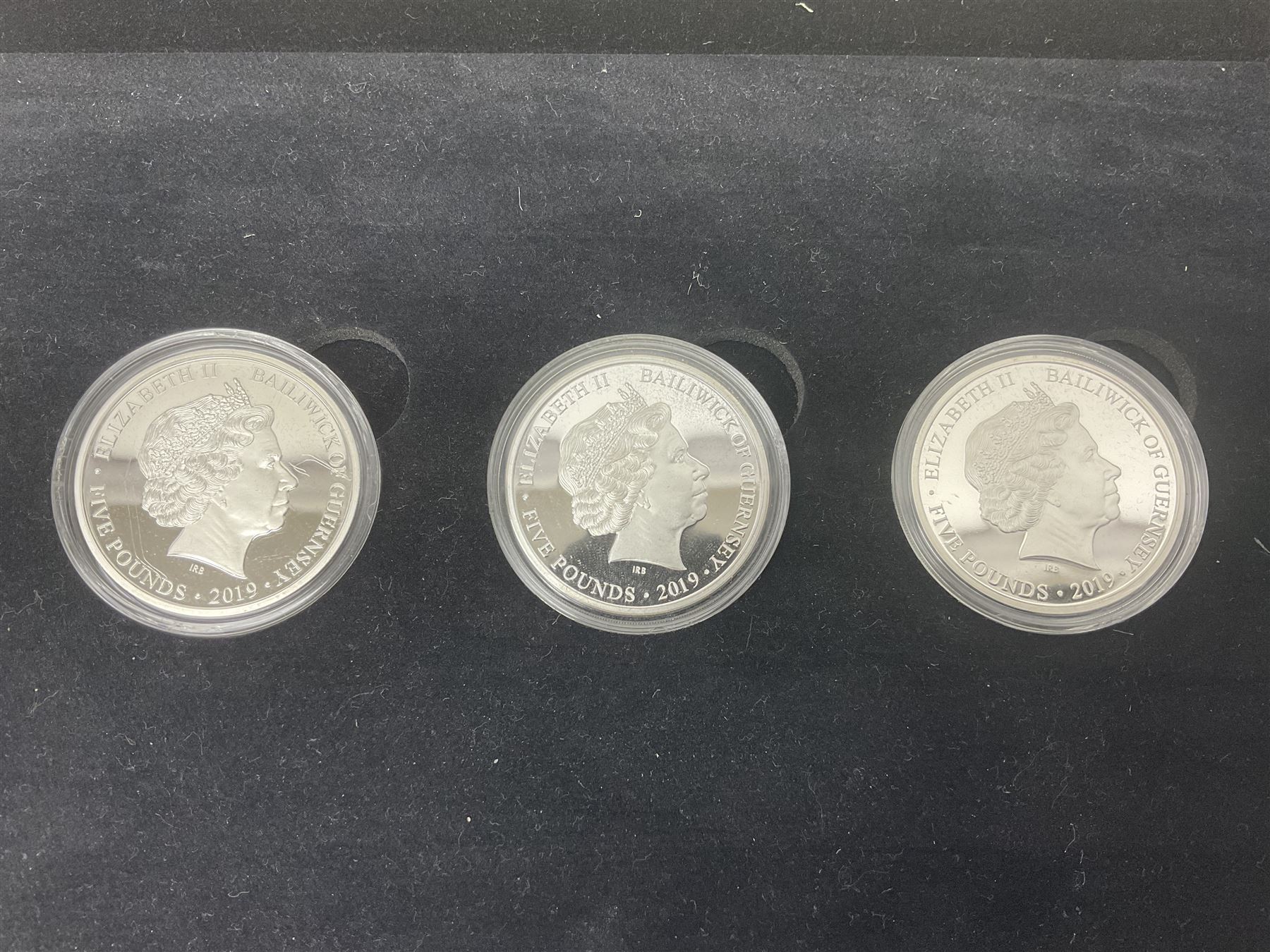 Queen Elizabeth II Channel Islands and Isle of Man silver proof five pound coins, comprising Bailiwick of Jersey 2016 'Lest we Forget', 2019 'D-Day 75th Anniversary' three coin set', Bailiwick of Guernsey 2020 'Florence Nightingale 200th Anniversary' and Isle of Man 2021 'William and Kate Wedding Anniversary', all cased with certificates