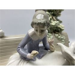 Lladro figure, Feeding the Pigeons, modelled as a woman feeding pigeons on a bench, sculpted by Regino Torrijos, with original box, no 5428, year issued 1987, year retired 1989, H23cm 
