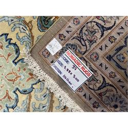 Central Persian Kashan hand-knotted carpet, ivory field with scrolling vines, palmettes, and rosettes around a cusped medallion with pendants and spandrels within a blue ground border of palmettes and flowerheads, 388cm x 300cm