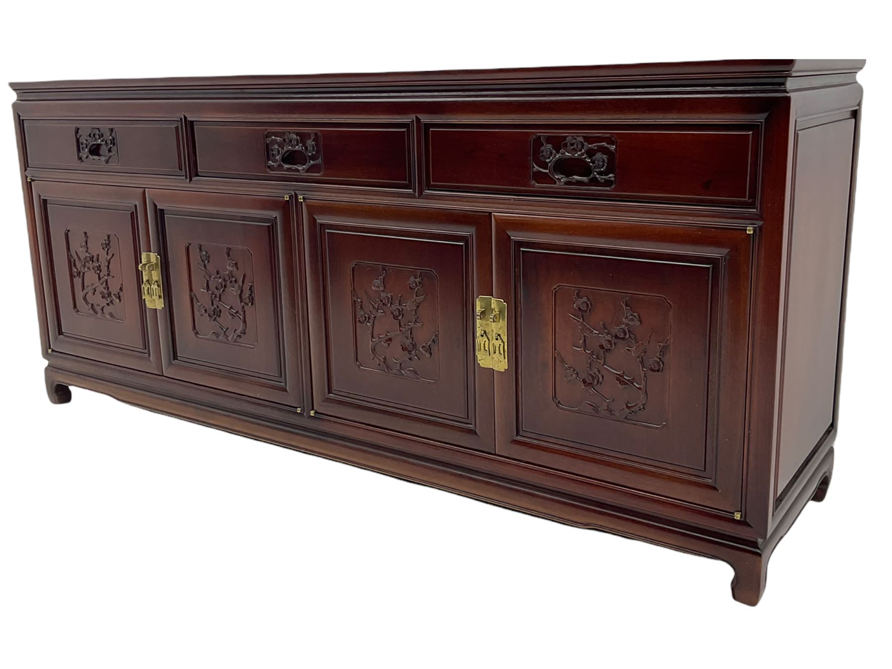 Chinese hardwood sideboard, three drawers above four cupboards, the doors relief carved with flowers and birds 