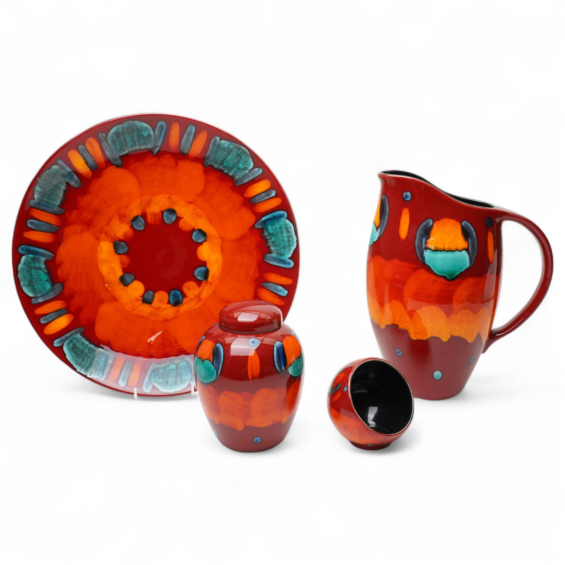 Four Poole pottery 'Volcano' pattern items comprising charger