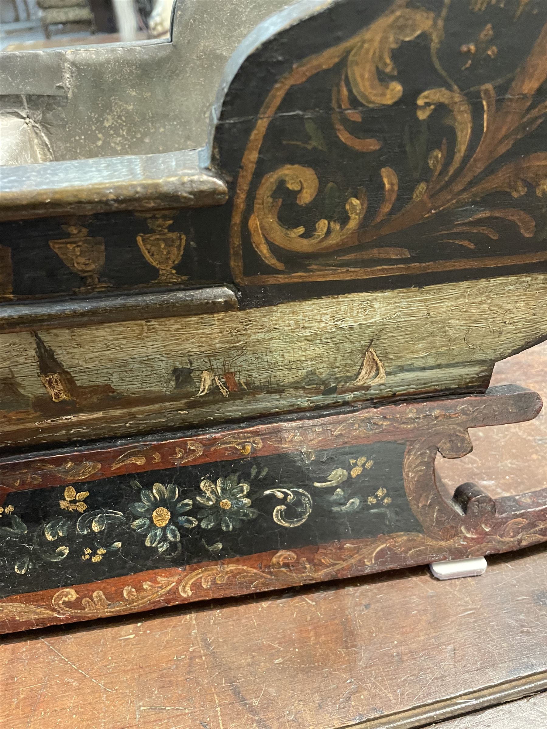 Unusual 18th century small Northern European wooden sled, with curved scroll back, the sides painted with coastal shipping scenes, the interior with removable zinc liner, upon curved irons painted with flower heads, H36cm W56cm D29cm