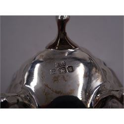 Early 20th century silver mustard pot and cover, of faceted oval form, with shaped rim and acanthus capped scroll handle, upon four pad feet, with matching spoon, H5.5cm, hallmarked I S Greenberg & Co, Birmingham 1912 & 1914, with blue glass liner, together with pair of Victorian silver open salts, of fluted circular form, with lobed rim, upon three pad feet, with matching salt spoons, all hallmarked Atkin Brothers, Sheffield 1899 and a Victorian silver pepper, of waisted baluster form, the part fluted body repousse decorated with flowers and leaves and a floral garland to upper rim, hallmarked William Oliver, Birmingham 1900