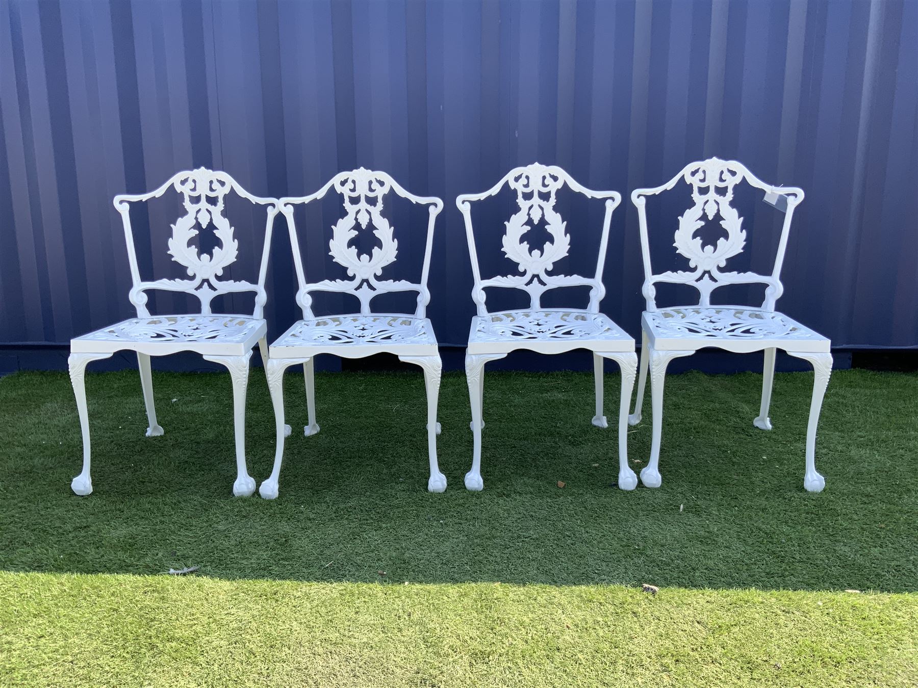 Set four Victorian style white painted cast metal garden chairs, and an additional white painted cast metal chair  - THIS LOT IS TO BE COLLECTED BY APPOINTMENT FROM DUGGLEBY STORAGE, GREAT HILL, EASTFIELD, SCARBOROUGH, YO11 3TX
