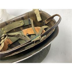 American first type paratrooper helmet with post-WW2 strap and D-rings and later 1944 liner bearing Firestone Tyre and Rubber Company mark; green textured finish