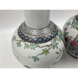Pair of Chinese Republic porcelain vases, each painted in Famille Rose enamels with pairs of pigeons amidst peony, rock, flowering plants and leafy branches, possibly Qianlong seal beneath, H22cm 