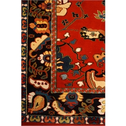  Turkish red ground rug, field filled with multi coloured trailing stylised foliage within a repeating border, 280cm x 198cm  