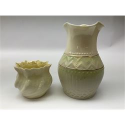 Quantity of Belleek ceramics to include mid-late 19th century jug moulded with green man mask and foliage, date code stamp for 1863-1890, together with later Belleek cornucopia shape vase, jug and other vases together with a Belleek style shell dish raised on branches, tallest H19cm