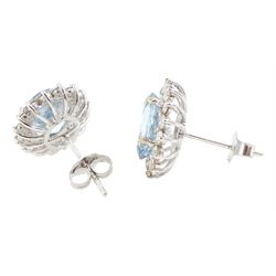 Pair of 18ct white gold oval cut aquamarine and round brilliant cut diamond cluster stud earrings, total aquamarine weight 5.00 carat, total diamond weight approx 1.05 carat