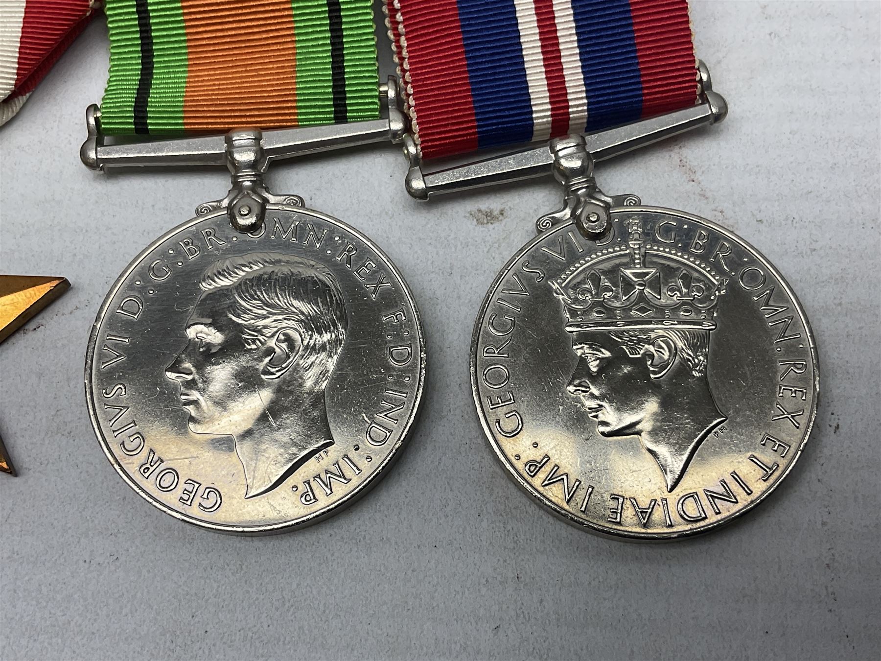 WW2 group of four medals comprising 1939-1945 War Medal, Defence Medal, Italy Star and 1939-1945 Star; with Royal Army Service Corps cap badge and RASC chrome and enamel sweetheart brooch