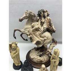 Composite figure of a couple upon a rearing horse, together with a collection of resin immortals and two bone chests 