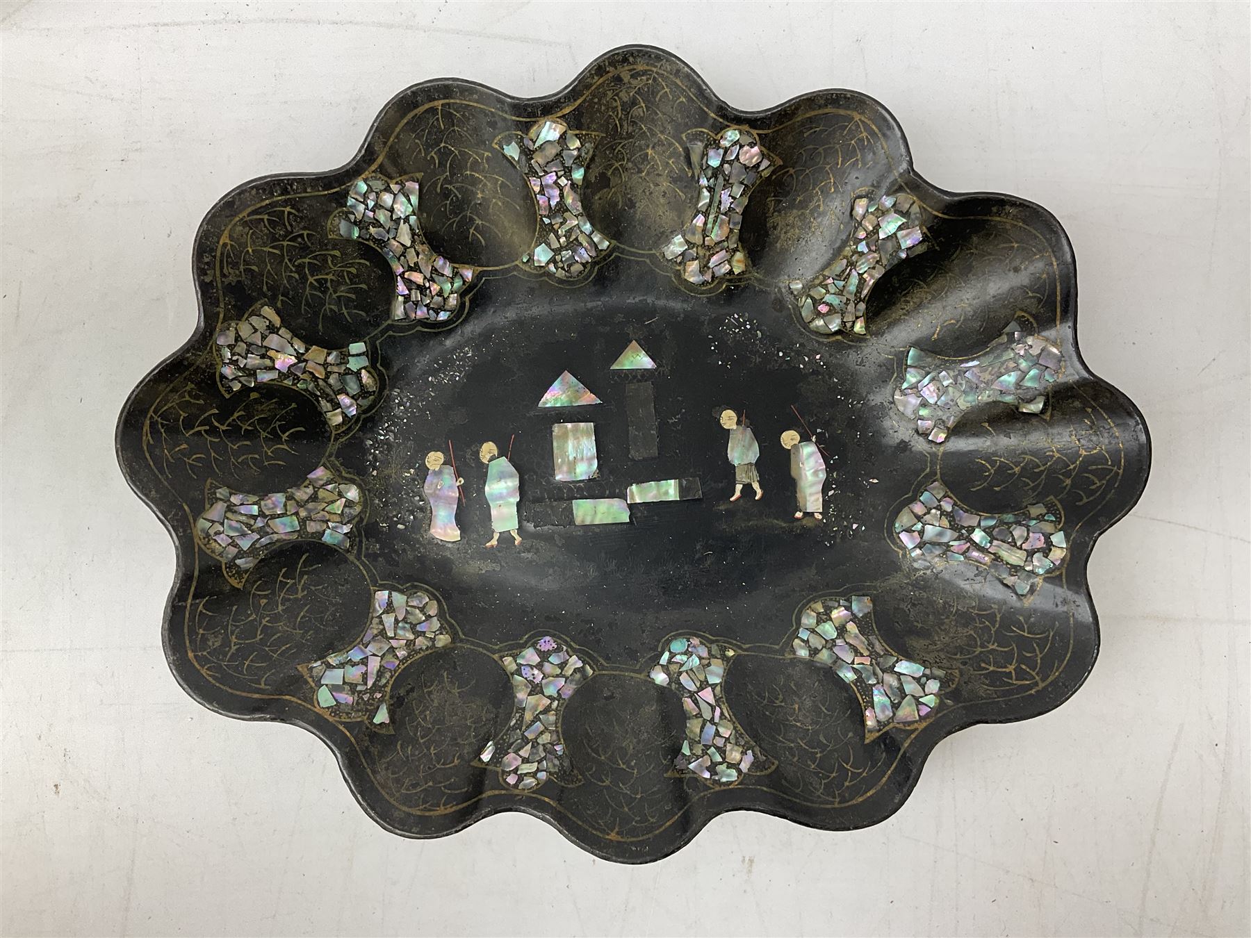  Late 19th / early 20th century Japanese lacquered table top cabinet, heavily decorated with mother of pearl inlay depicting blossoming branches, flowers and birds, the two hinged doors between longer drawers opening to reveal interior fitted with four short drawers, with lift up hinged canted lid, H28cm D9.5cm W23cm, together with mother of pearl inlaid miniature folding screen, dish decorated with walking figures with crimped edge, boxes decorated with flowers, birds and gilt etc