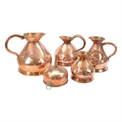 Set of four graduating copper jugs and a copper funnel, largest jug H32cm