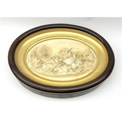 19th century oval plaster relief plaque depicting a battle scene, inscribed Justin, in mahogany stained frame, overall L48cm H37cm.