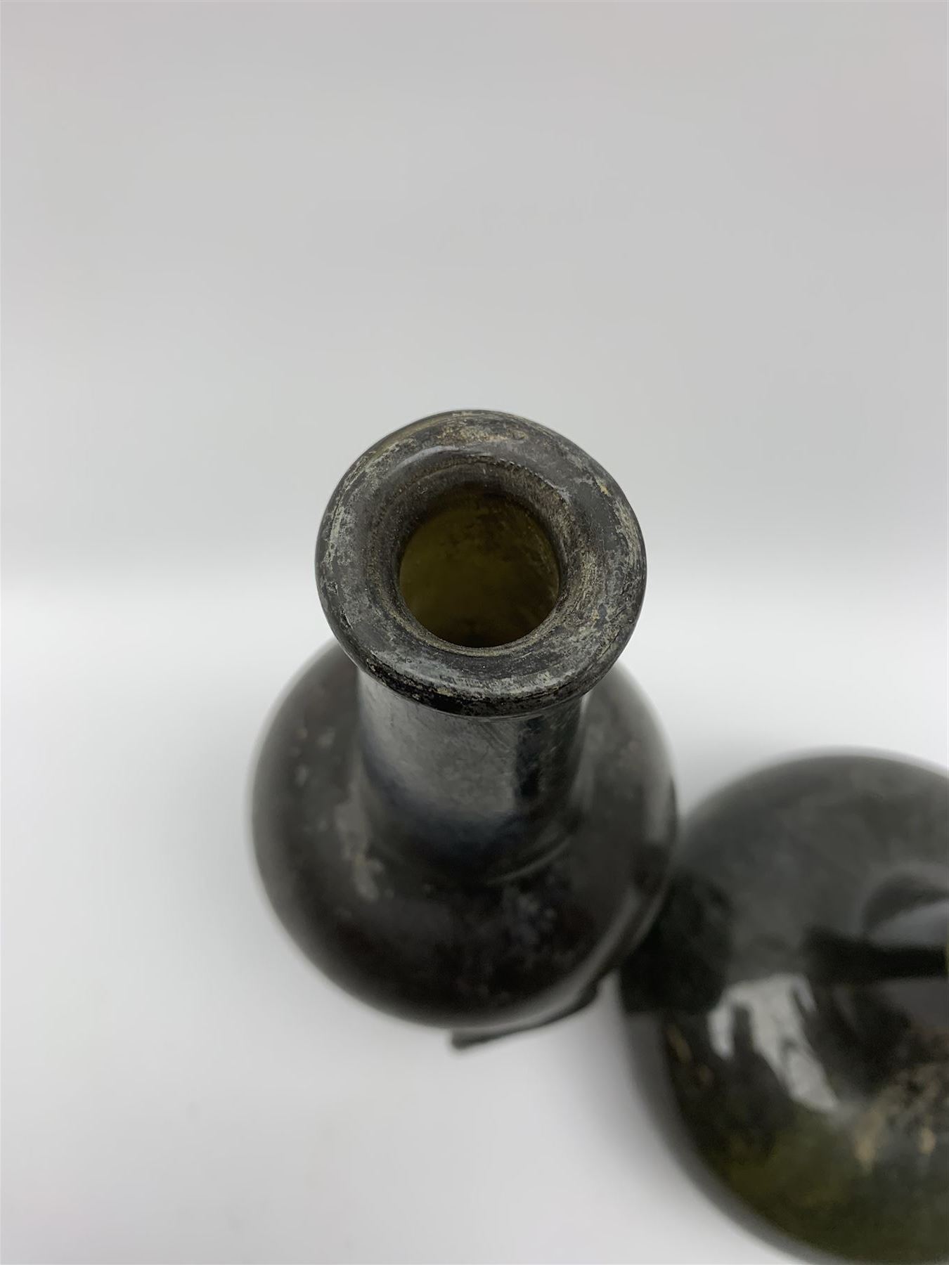 18th century green glass bottle, of onion form, H15cm, together with an 18th century green glass wine bottle, with seal depicting a boar beneath a crown, probably the Edgcumbe Crest, H27cm