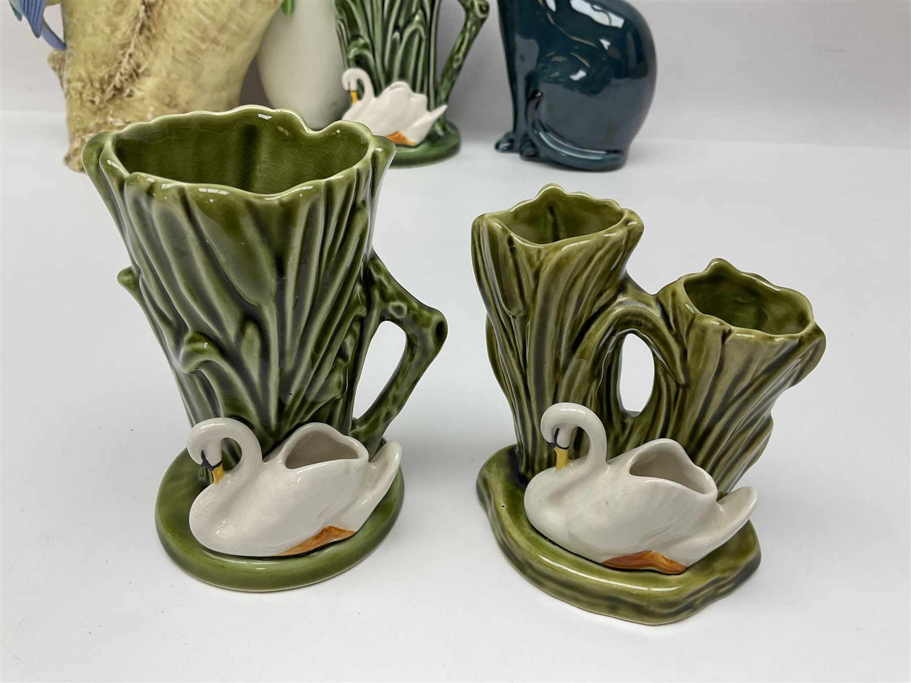 Sylvac budgieregar wall pocket, together with other Sylvac cermics including swan vases, blue tit vase and a frog figure etc, all with printed or impressed marks beneath, and a Poole Pottery cat figure, with printed mark beneath, wall pocket H22cm