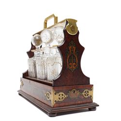 Amboyna three bottle tantalus, the cut glass spirit decanters decorated with raised naturalistic decoration heightened in gilt, with brass corner mounts and singular carrying handle, H32cm