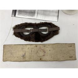 WW1 British Army Derby Scheme 1915 Attested armband; beret with East Yorkshire cap badge; pair of fur lined leather flying/motorcycle goggles; HMS Pembroke cap band; and small quantity of RNAS cloth and metal badges etc