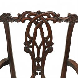 Chippendale revival mahogany dining chairs, set of six including a pair of carvers, the backs with intricately carved pierced splats beneath serpentine cresting rails, on acanthus carved cabriole front supports terminating in claw and ball feet, with cream upholstered drop-in seats