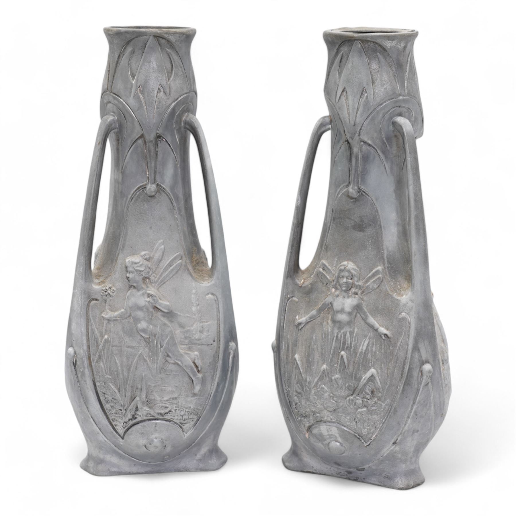 Jean Garnier (French 1853-1910): Pair of Art Nouveau cast metal vases, possibly spelter, of three handled form, cast in relief with panels of fairies, signed J. Garnier, H38cm 