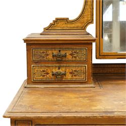 Late Victorian Aesthetic Movement scumbled and painted pine dressing table, arched swing mirror over four small trinket drawers, decorated with painted ebonised stringing and Aesthetic Movement motifs, rectangular top fitted with two drawers, on turned supports