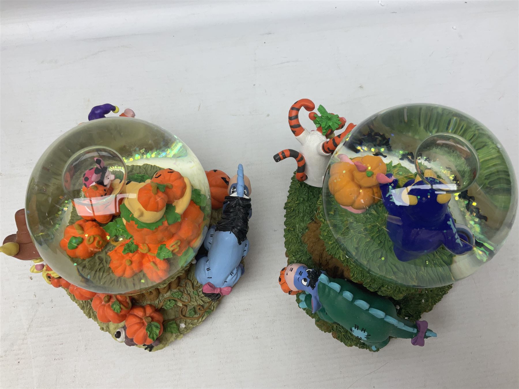 Six Disney Winnie The Pooh snow globes, to include four Halloween examples, including Tigger's Haunted House, together with Winnie The Pooh Gazebo snow globe and Bonfire snow globe, all with boxes