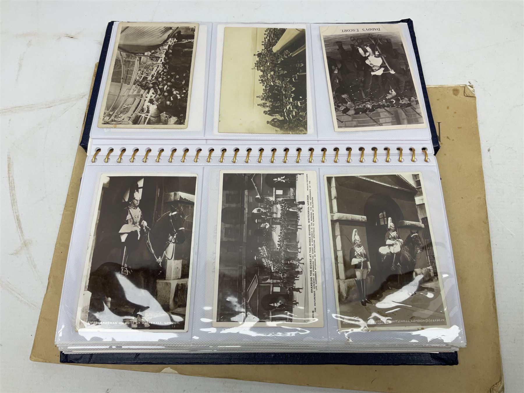 Modern album containing over sixty postcards and photographs including memorial portraits of KIA soldiers, regimental crests, comic, WW1 embroidered silk, uniforms, cap badges, camp and manoeuvre images etc; another personal photograph album of WW2 soldiers relaxing; Royal Armoured Corps booklet 'The Italian Campaign 3rd Sep. 1943 - 2nd May 1945; and other paper ephemera of military interest