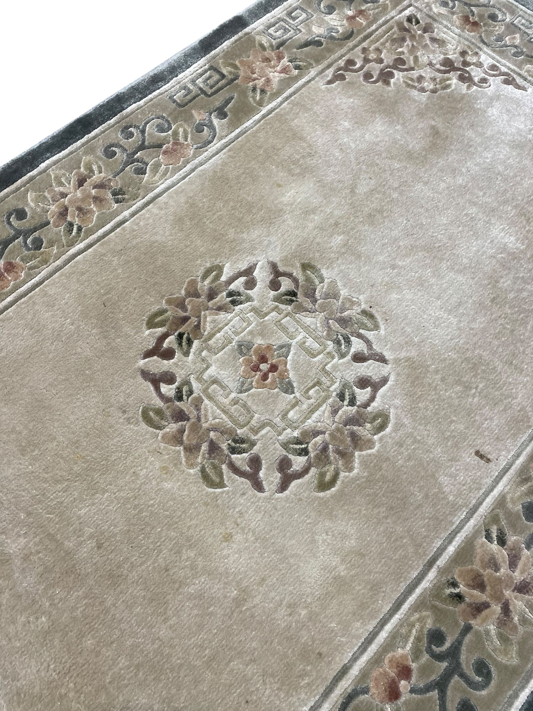 Chinese washed woollen camel ground rug, circular medallion surrounded by scrolls, the border decorated with birds and trailing floral decoration (248cm x 155cm); Chinese washed woollen pale green ground rug (125cm x 69cm); Persian design rug (186cm x 121cm) (3)