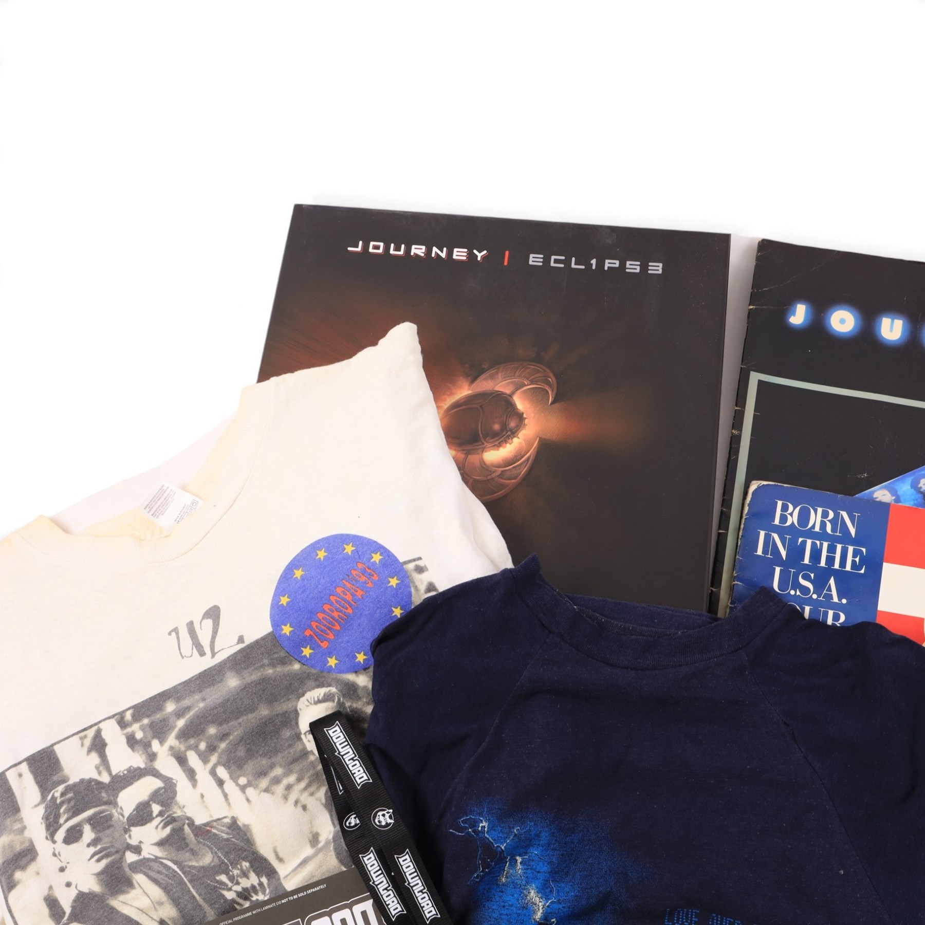 Collection of 1980s and later music tour merchandise and records, including Dire Straits Love Over Gold t-shirt, U2 Zooropa t-shirt, Bruce Springsteen Born In The USA tour programme, Bruce Springsteen Cover Me Stand Up picture disc and sleeve, Bruce Springsteen Born In The USA picture disc, Bruce Springsteen Western Stars limited edition coloured vinyl, Depeche Mode Singles Tour programme 1986-88, Journey 1986 programme and ticket stub, Journey Eclipse Collectors Edition Set and 2017 Download Festival passes