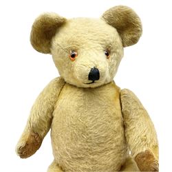 Large mid-20th century English teddy bear, the revolving head with applied eyes, vertically stitched nose and mouth and jointed body with growler mechanism H67cm; and two other similar large teddy bears (3)