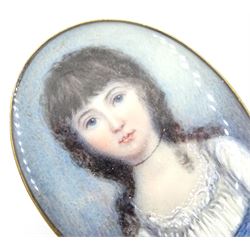 British School (18th century and later)
Two portrait miniatures upon ivory
The first example a head and shoulder portrait of a young woman wearing a white gown
In period gold brooch mount with garnet border 
Oval 4cm x 3.25cm
The second a head and shoulder portrait of a young girl in blue and white dress
In gilt brooch mount with hair work panel verso
Oval 4.5cm x 3.5cm
