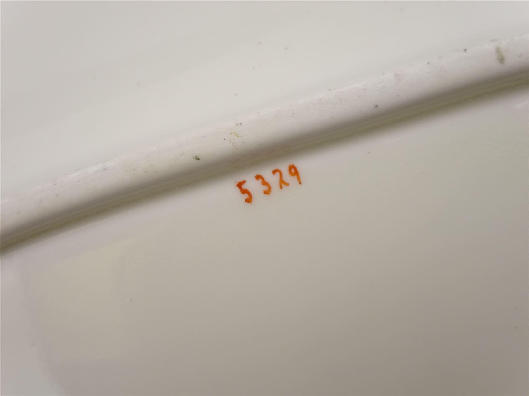 19th century Minton tea set, comprising twelve teacups, eleven saucers, fifteen side plates, cream jug, slop bowl, and two cake plates, decorated with panels of floral sprays, upon a green ground, heightened with gilt throughout, with printed puce mark beneath, and pattern number 5329
