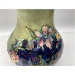 Moorcroft vase of baluster form decorated in the Spring Flowers pattern upon a merging green and blue ground, with impressed and painted marks beneath, H22.5cm